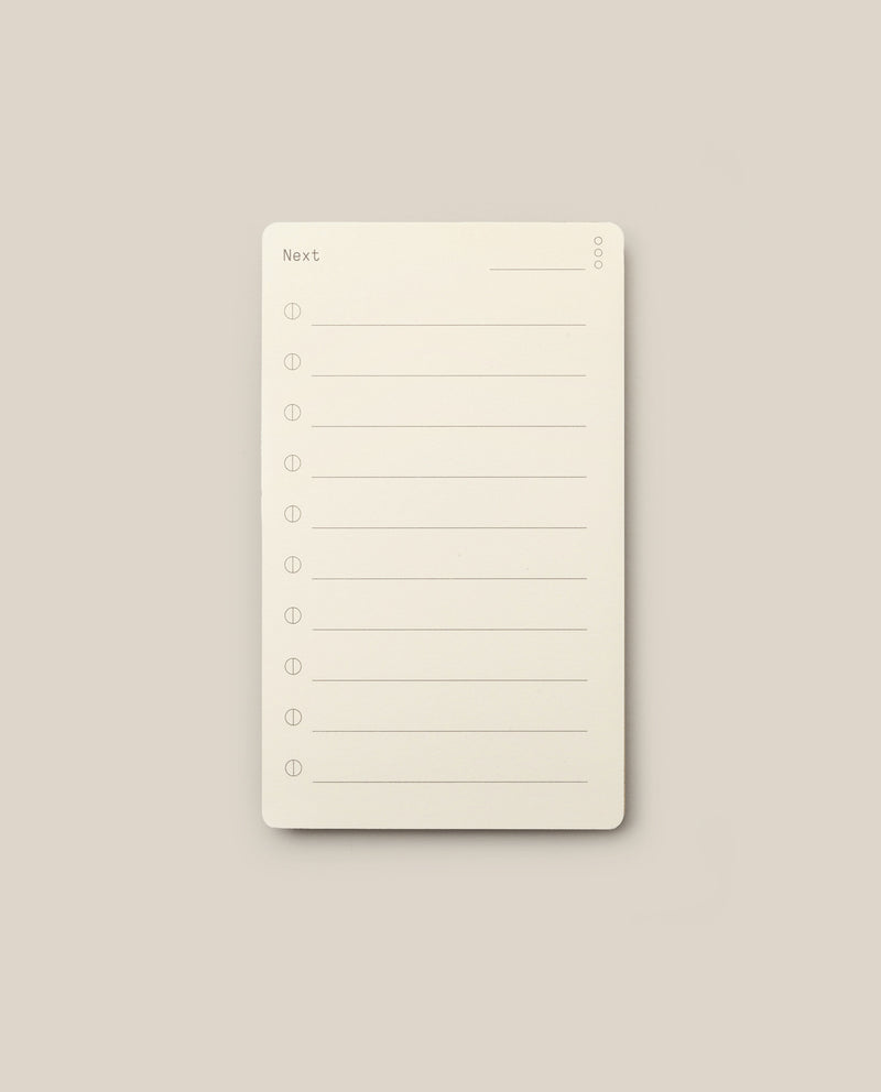 Analog - Next Cards: Notepads featuring the word “Next” at the top and eight numbered lines for writing tasks or notes, set against a plain beige background—perfect for goal setting or capturing ideas on Analog - Next Cards.