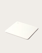 A minimalist, rectangular white Gather 2x2 Organizer Set with rounded corners and a corner hole, crafted from powder-coated steel to match your customizable desk organizer—shown on a light, neutral background.