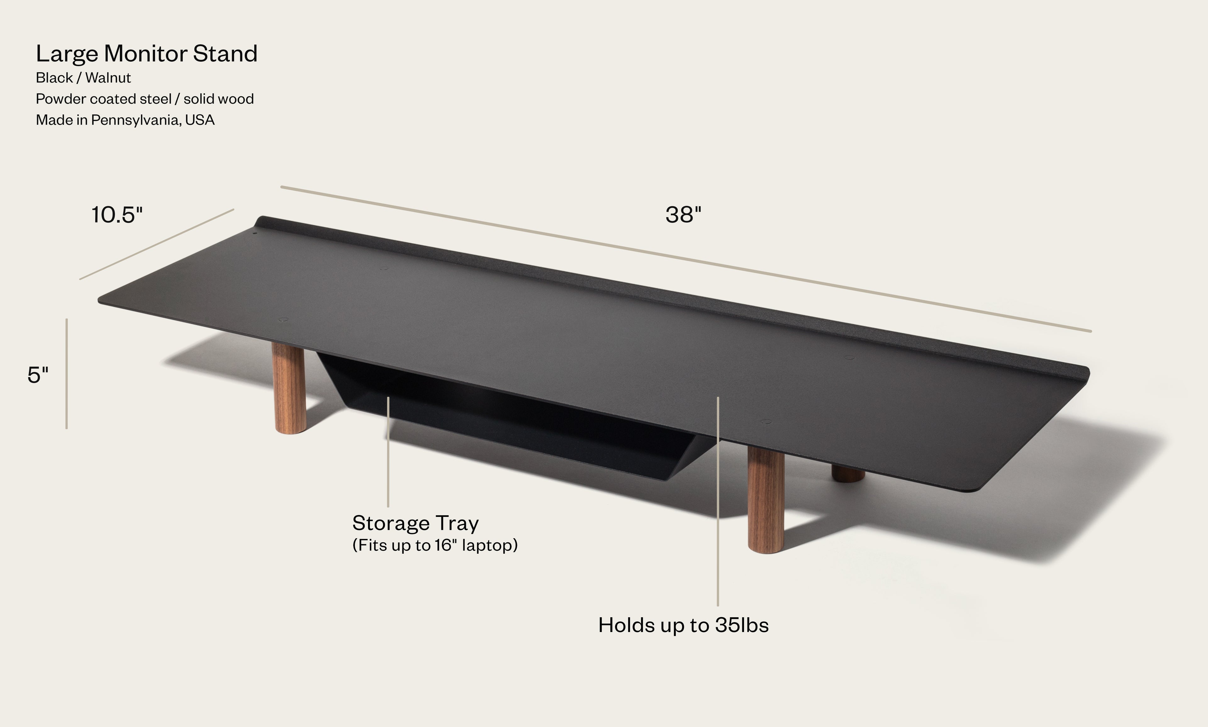 The Gather Large Monitor Stand (Black/Walnut) features solid wood legs, a powder-coated steel surface, a built-in storage tray for up to a 16" laptop, measures 38 x 10.5 x 5", and supports up to 35 lbs.
