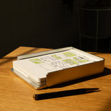 The Analog Capture Kit - Large (Silver Aluminum) features large dot grid cards with diagrams and green highlights in a sleek aluminum tray on a wooden table, accompanied by a black and gold pen under warm sunlight.