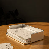 The Complete Analog Collection (Silver Aluminum) rests on a wooden table, holding handwritten notes and sketches in warm sunlight, with extra index cards neatly arranged beside this elegant aluminum organizer.