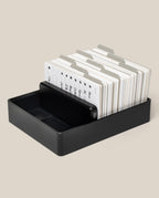 Analog Archive (Black Aluminum) card holder filled with a stack of white index cards organized by metal tabbed dividers.