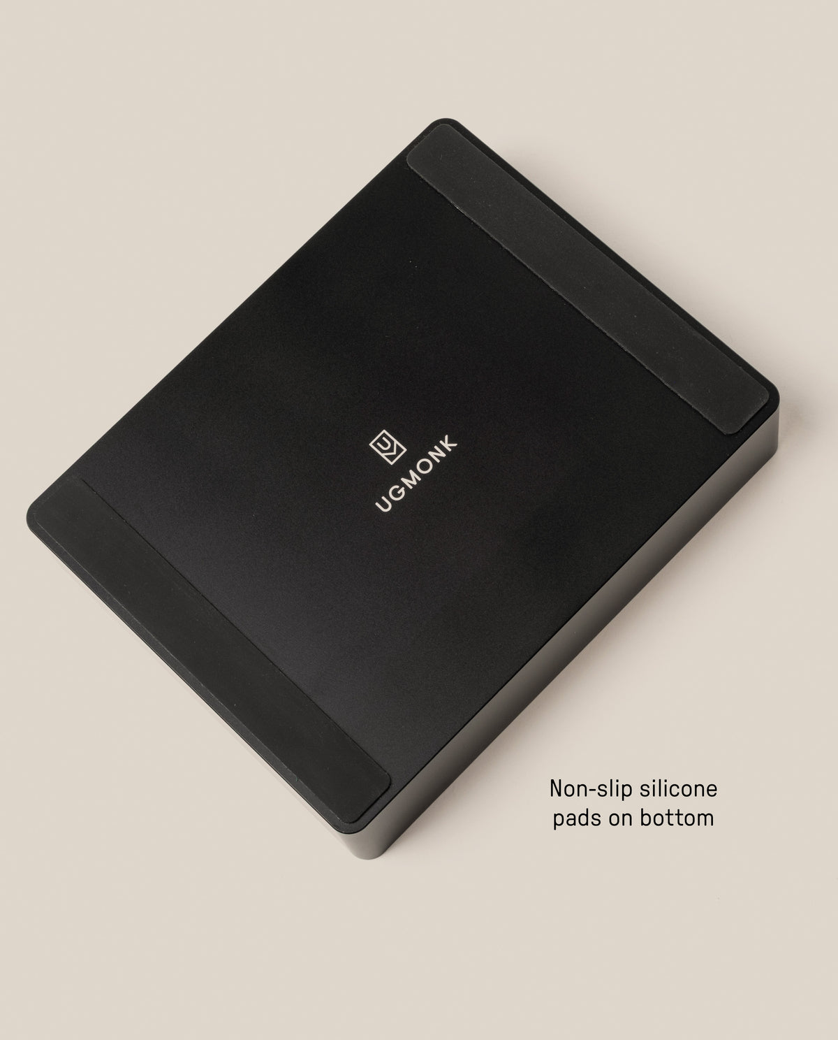 The Analog Archive (Black Aluminum) is a black rectangular solid aluminum card holder with a logo in the center and two non-slip silicone pads on the bottom.