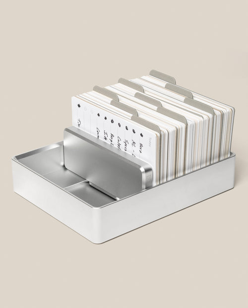 An Analog Archive (Silver Aluminum) card holder filled with tabbed index cards.