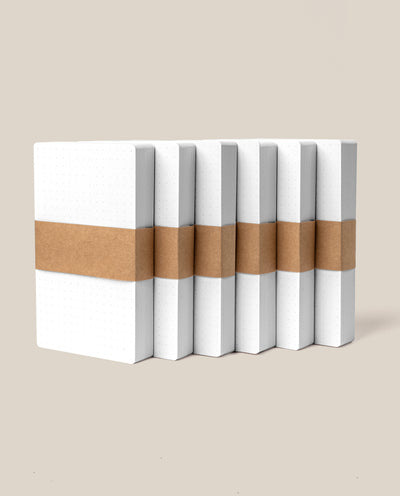 Six Analog Dot Grid Cards - Small (6-Pack) are arranged upright in a row against a beige background, ideal for note taking or pairing with 3x5 cards.