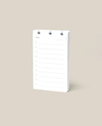 A Discbound Analog Refill (1-Pack), featuring lined pages for daily to-do lists, stands upright on a plain beige background.