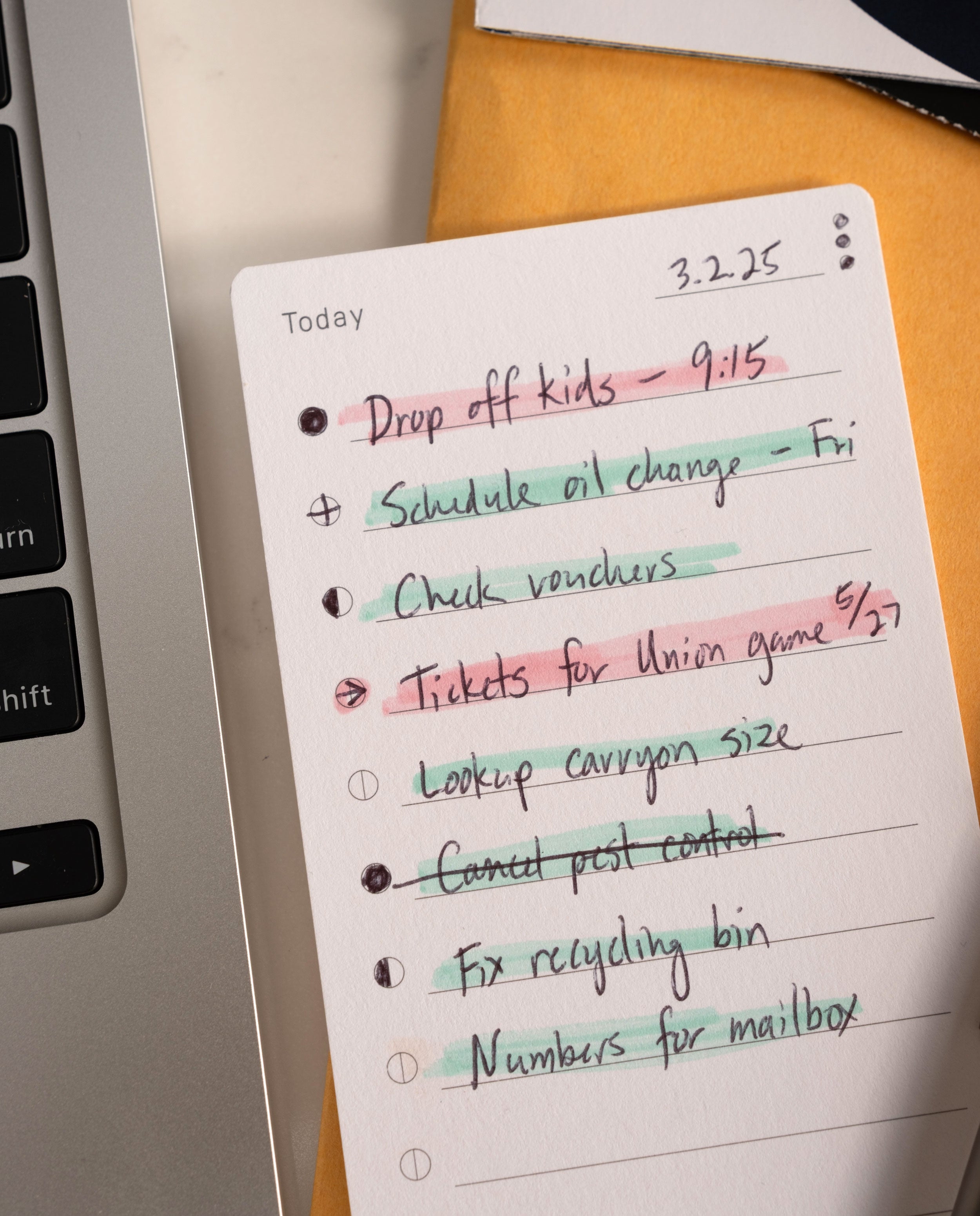 An Analog Trial Pack 3x5 card to-do list rests by a laptop, featuring handwritten tasks like Drop off kids and Schedule oil change—some crossed out in different colors. The date is 3.2.25, evoking classic index card vibes.