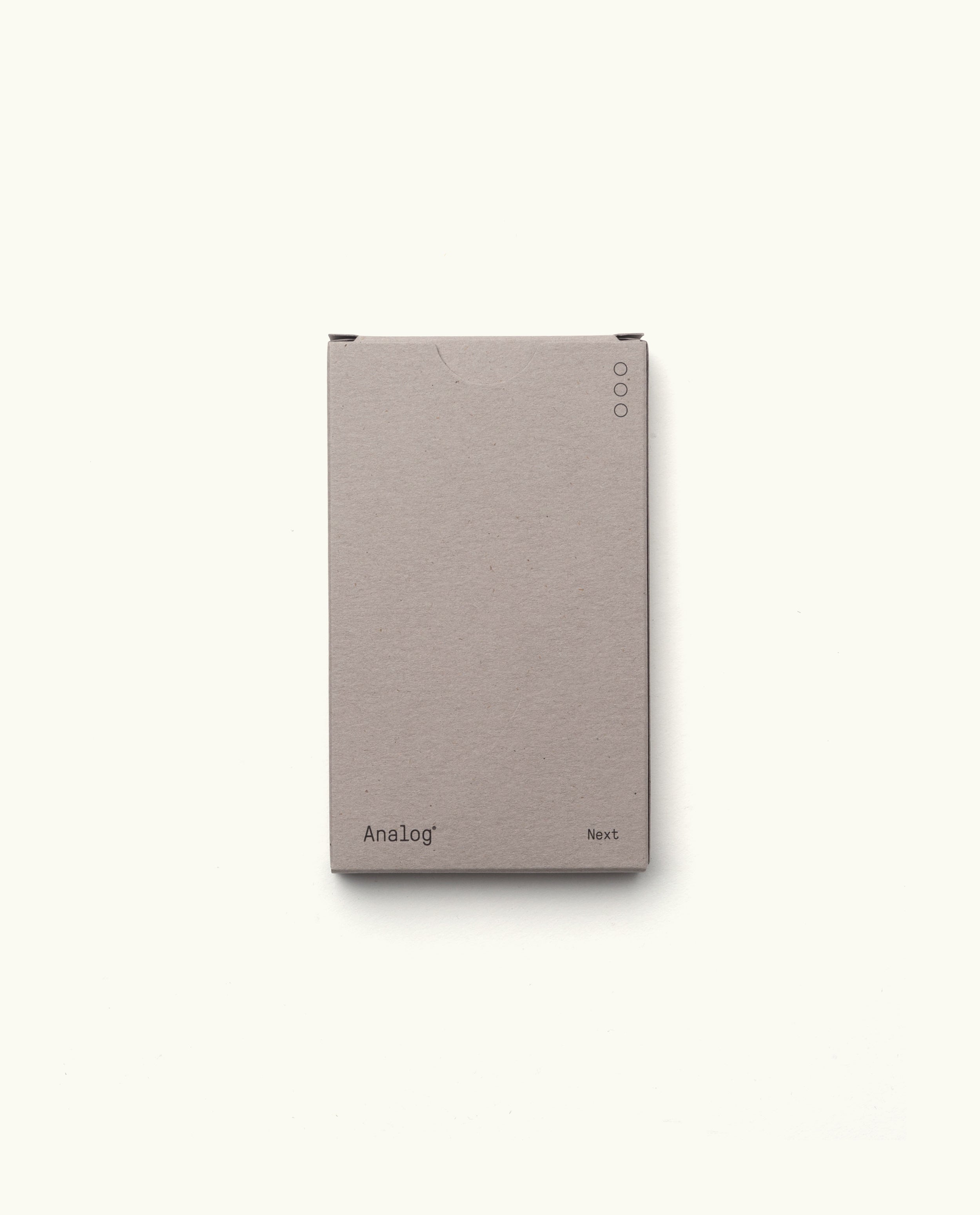 A plain, light gray rectangular box displaying “Analog - Next Cards (1-Pack)” on the bottom front, with three small circular icons in the top right—designed for organizing your dot grid cards for goal setting, shown on a white background.