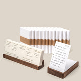 The Analog Annual Kit (Walnut) features white analog cards, some bound with brown bands, others displayed in walnut holders with handwritten notes, lists, and schedules—all set against a light beige background.