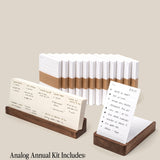 The image shows the Analog Annual Kit (Walnut) with walnut Daily and Weekly Card Holders, white cards (13 monthly, 52 weekly), two holders, and a detailed item list included in the set.