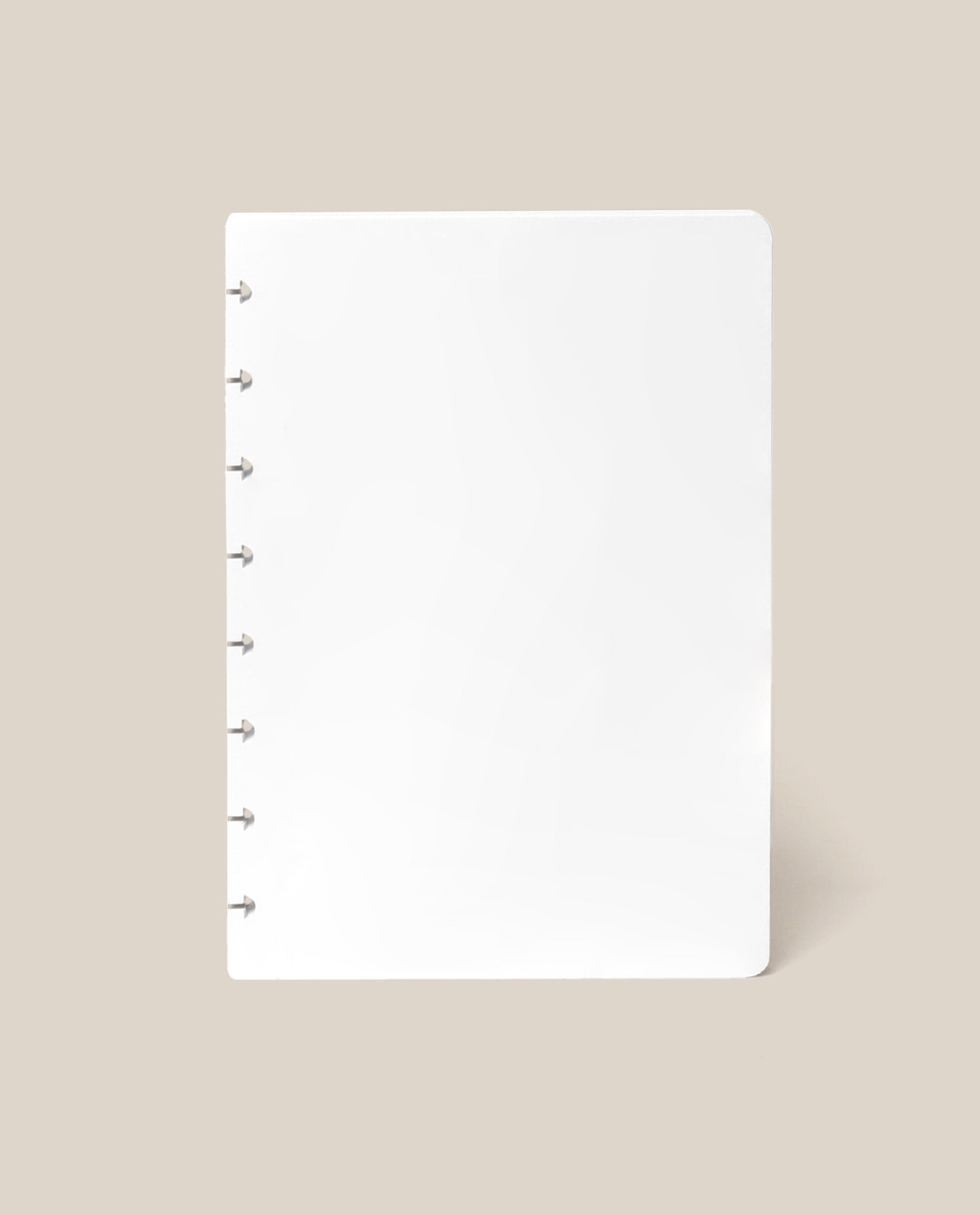 A Discbound Journal Refill - Blank (Standard 6″ x 8.5″) with six silver rings along the left edge, reminiscent of an Heirloom Discbound Journal, is centered on a beige background.