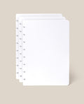 Three blank, white Discbound Journal Refill pages (Standard 6″ x 8.5″)—perfect for adding to your Heirloom Discbound Journal—are stacked together with visible mushroom-shaped holes on the left edge, displayed against a light beige background.