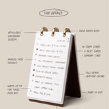 Desk calendar with features listed on a beige background