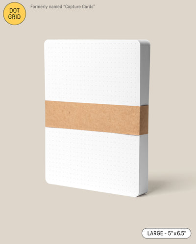 A pack of large (5" x 6.5") Analog Dot Grid Cards—white with rounded corners, held by a brown paper band; ideal for sketching or notes. Previously known as Capture Cards.