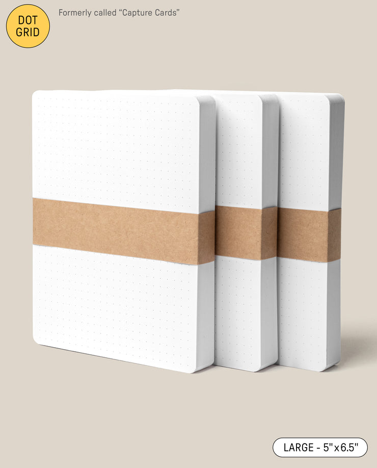 Three Analog Dot Grid Cards - Large (3-Pack) are stacked and secured with brown paper bands on a light beige background. A label displays their LARGE 5” x 6.5” size, making them ideal for note taking.