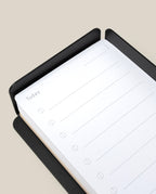 A close-up of a black notepad opened to the "Today" planner page sits beside the Capture Bundle (Small Tray + Large Tray - Black Steel), perfect for organizing desk essentials.