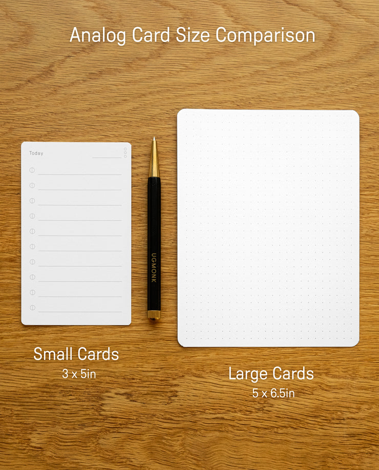 Two analog cards sit on a wooden surface: a lined 3x5" notecard and an Analog Dot Grid Card - Small (from the 12-Pack, 5x6.5"). A pen rests between them for scale, with text labels showing each card’s size.