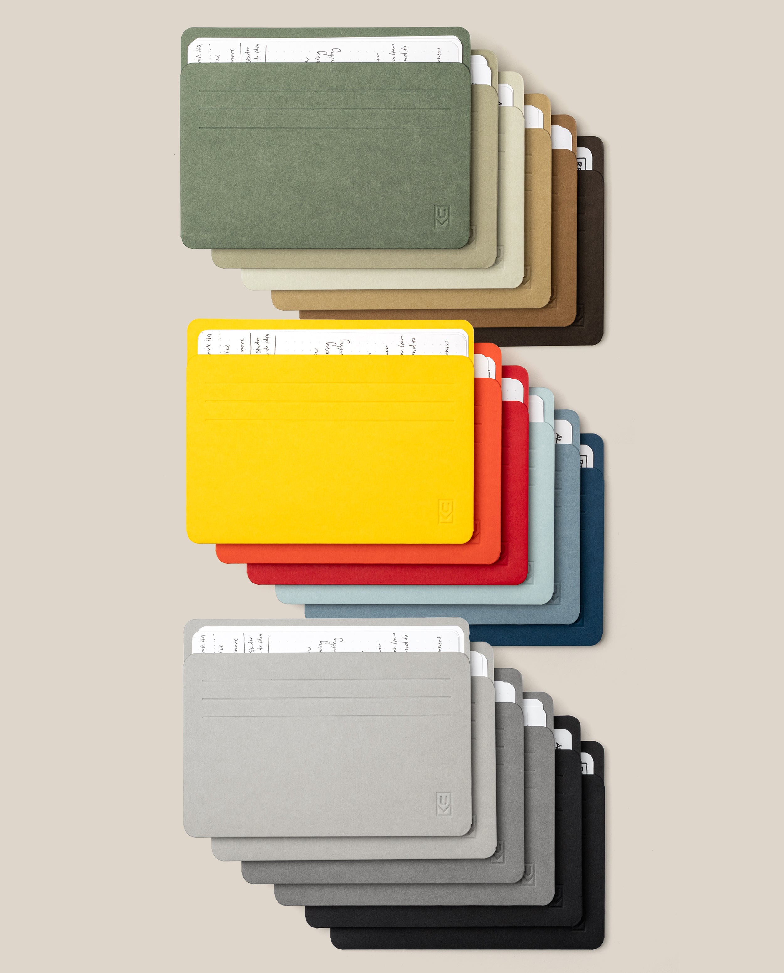 Eighteen Large Analog Card Sleeve Multipacks in assorted colors, organized in three neat rows. Each card sleeve serves as a sleek card organizer, with cards partially visible to highlight the slots and minimalist design against a neutral background.