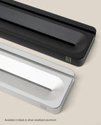 The Analog Card Bar (Small 10" - Black) is shown alongside a silver version on a beige background. Both anodized aluminum desk organizers have a front slot, small logo, and are available in black or silver.