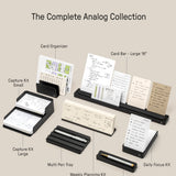 A neatly arranged display of The Complete Analog Collection (Black Aluminum), featuring card organizers, card bars, a planning kit, two capture kits, multi pen trays, and a daily focus kit on a beige background.