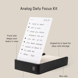 The Analog Daily Focus Kit + 6 Refills (Black Aluminum) is a rectangular black aluminum desk tray with a front card slot, angled lip, non-slip silicone pads, solid build, and measures 6.25 x 3.55 x 1.15 inches.