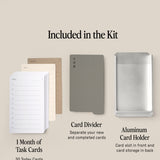 The Analog Daily Focus Kit (Silver Aluminum) features a month's worth of Task Cards, a gray card divider, and an Aluminum Card Holder—each clearly labeled, all part of a system designed to streamline your workflow.