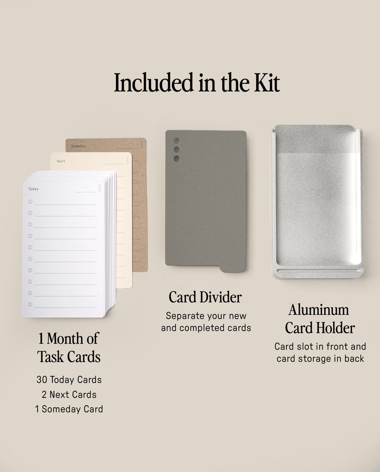 The Analog Daily Focus Kit (Silver Aluminum) features a month's worth of Task Cards, a gray card divider, and an Aluminum Card Holder—each clearly labeled, all part of a system designed to streamline your workflow.