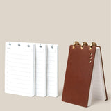 The Leather Discbound Analog + 3 Refills (Brown), a brown leather ring-bound notepad, stands upright beside three stacks of daily planner page refills on a light beige background.