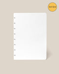 A white Discbound Journal Refill - Dot Grid (Standard 6″ x 8.5″) sheet featuring six disc-bound holes on the left is displayed against a beige background. In the top right corner, a yellow circle labeled “Dot Grid” highlights this as the ideal refill pack for your Heirloom Discbound Journal.