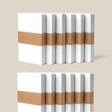 Twelve packs of Analog Dot Grid Cards - Small, neatly stacked with brown paper bands, are displayed on a beige background—ideal for organizing your notes with a total of 600 compact index cards.