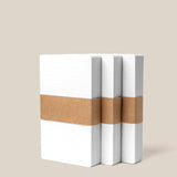 Three packs of Analog Dot Grid Cards - Small are displayed upright side by side, each set wrapped with a single brown paper band around the middle, against a plain beige background.