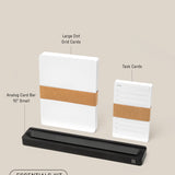 Photo of the Analog Card Bar - Essentials Kit (Black Aluminum), featuring a stack of large Dot Grid Cards, Task Cards, and a sleek black card bar stand, all labeled against a beige background.