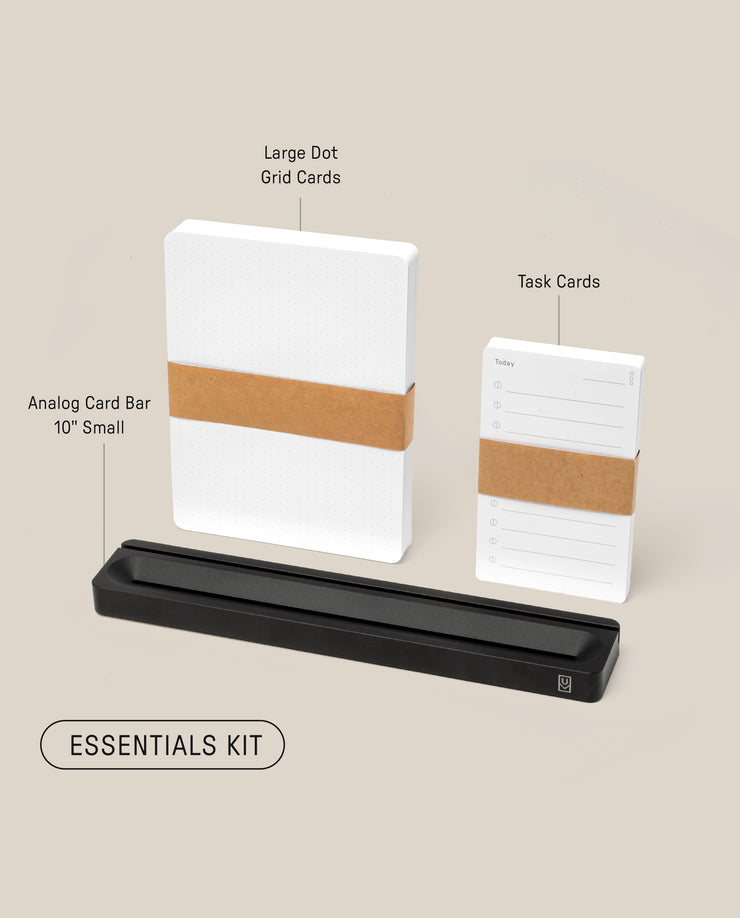 Photo of the Analog Card Bar - Essentials Kit (Black Aluminum), featuring a stack of large Dot Grid Cards, Task Cards, and a sleek black card bar stand, all labeled against a beige background.