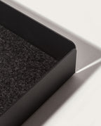 A close-up of the Gather Large Tray (2x2 - Black) featuring a textured dark felt interior and magnetic base, casting a shadow on a white surface in bright light.
