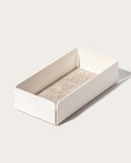 The Gather Medium Tray (2x1 - White) is a minimalist valet tray, crafted in Pennsylvania with rectangular powder-coated steel sides and a textured beige base, shown on a light background.
