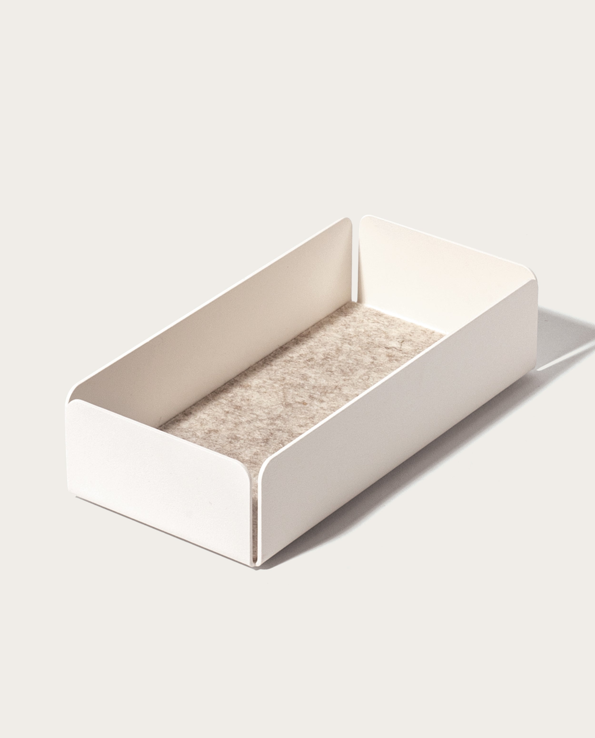 The Gather Medium Tray (2x1 - White) is a minimalist valet tray, crafted in Pennsylvania with rectangular powder-coated steel sides and a textured beige base, shown on a light background.