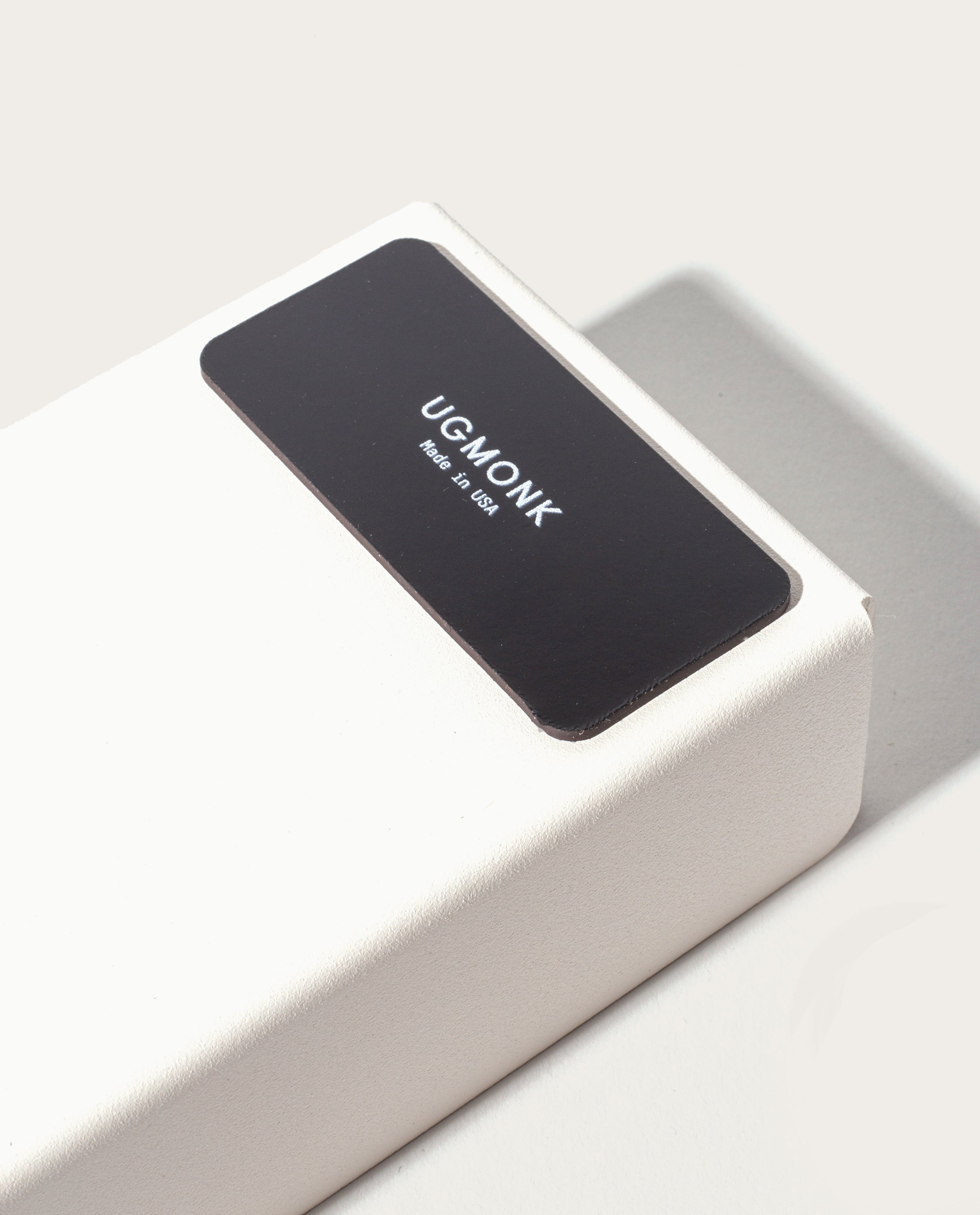 A close-up of the Gather Medium Tray (2x1 - White), a white rectangular box with a black label reading UGMONK Made in USA, made in Pennsylvania, casting a soft shadow on a light background.