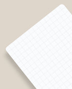 A pack of Analog - Graph Cards (3-Pack) featuring white sheets with light gray grid lines, rounded corners, and subtle shadows, arranged diagonally on a beige surface—reminiscent of classic 3x5 graph paper.