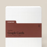 A pack of Analog Graph Cards - Large with a white grid background, brown label reading “Graph Cards, 50 Cards, 5x6.5in, 100lb,” and rounded corners. Made from sturdy uncoated cardstock for sketching, brainstorming, or note-taking.