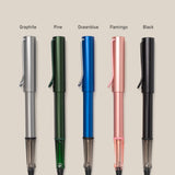 Five LAMY AL-star Rollerball pens—graphite (silver), pine (green), ocean blue, flamingo (pink), and black—are arranged vertically on a beige background. Each refillable pen is labeled above and designed for smooth writing.