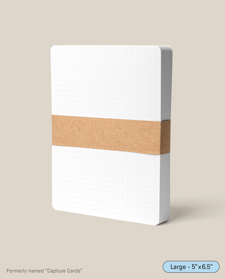 Analog Dot Grid Cards - Large (1-Pack) are made from premium card stock, sized 5x6.5 inches, and wrapped with a brown paper band. Previously called Capture Cards, they're ideal for organized note taking.