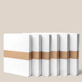 Six stacks of Analog Dot Grid Cards - Large (6-Pack), made from premium card stock, stand upright with brown paper bands. The cards are 5 x 6.5 inches for note taking and were formerly called Capture Cards.