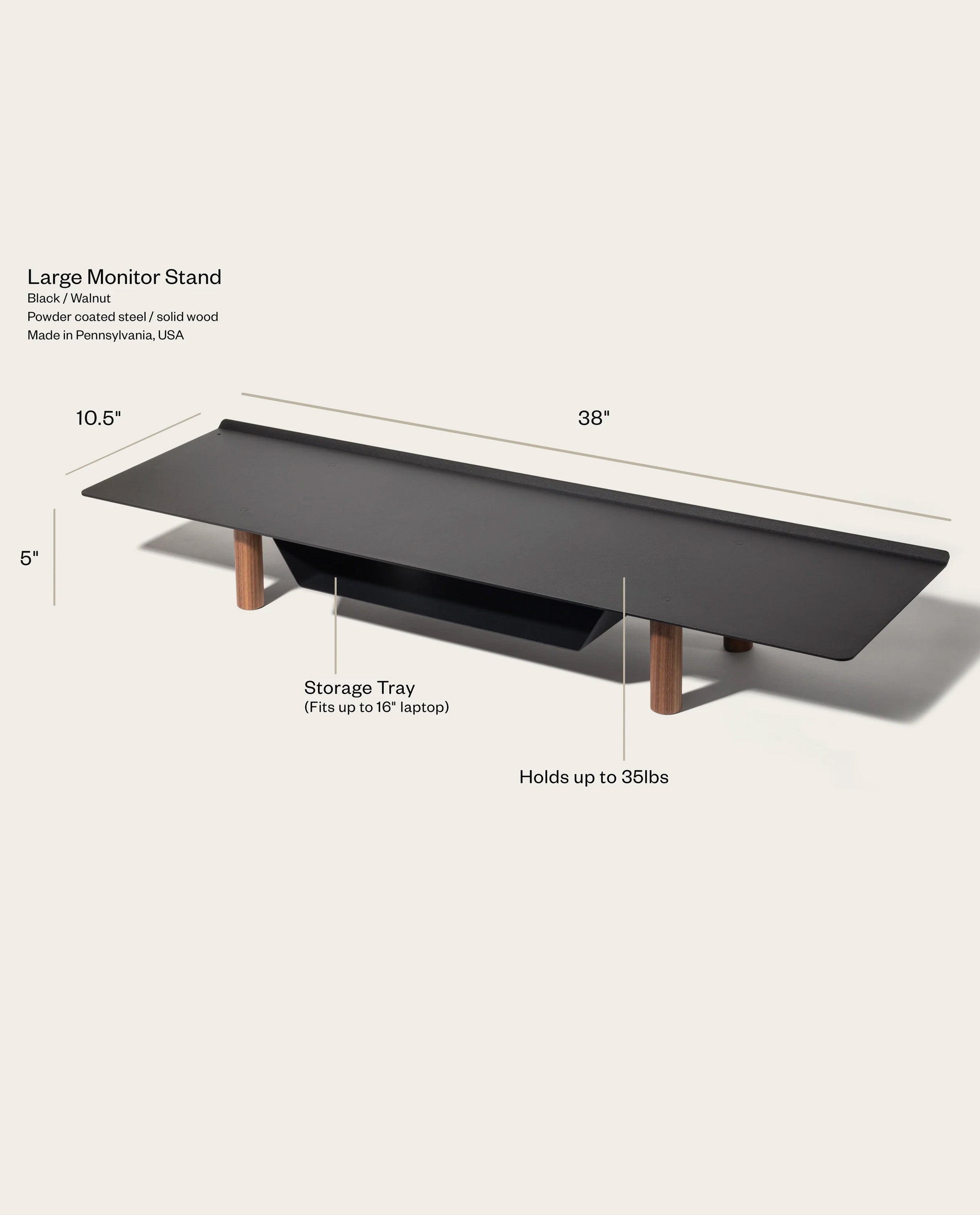 The Gather Large Monitor Stand (Black/Walnut) is a 38" wide by 5" tall organizer made from powder-coated steel and walnut, featuring a storage tray for up to a 16" laptop and supporting up to 35 lbs. Features and dimensions are highlighted.