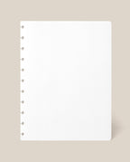 A Large Discbound Journal Refill - Dot Grid (8.5″ x 11″) sheet, featuring a square white page with round discbound holes along the left edge, is displayed against a light beige background.