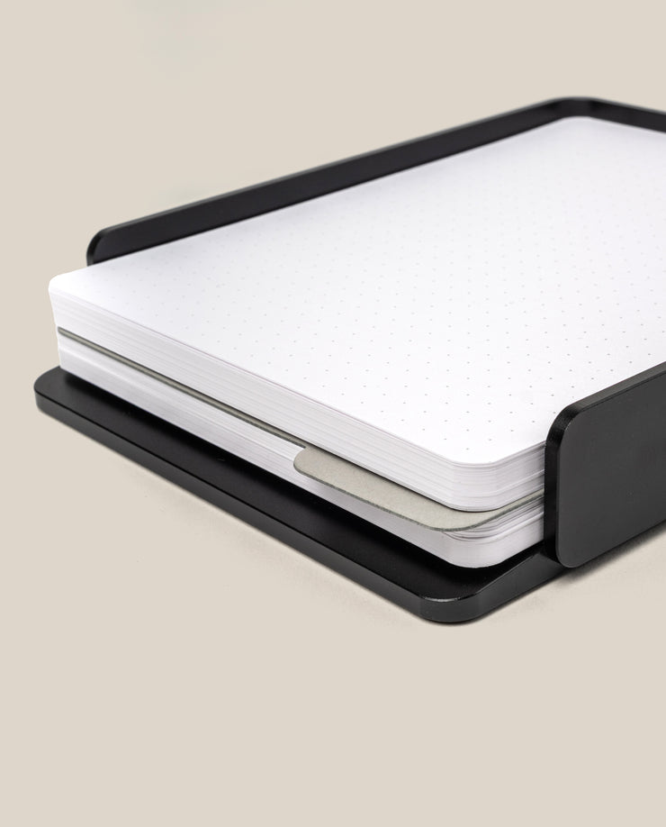 A stack of large dot grid cards with rounded corners sits in a sleek black aluminum tray—the Analog Capture Kit - Large (Black Aluminum)—ideal for capturing ideas.