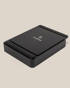 A black rectangular Analog Capture Kit - Small & Large (Black Aluminum) desktop organizer with rounded edges and the Ugmonk logo and name on top, set against a plain beige background.