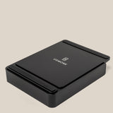 A black rectangular Analog Capture Kit - Small & Large (Black Aluminum) desktop organizer with rounded edges and the Ugmonk logo and name on top, set against a plain beige background.