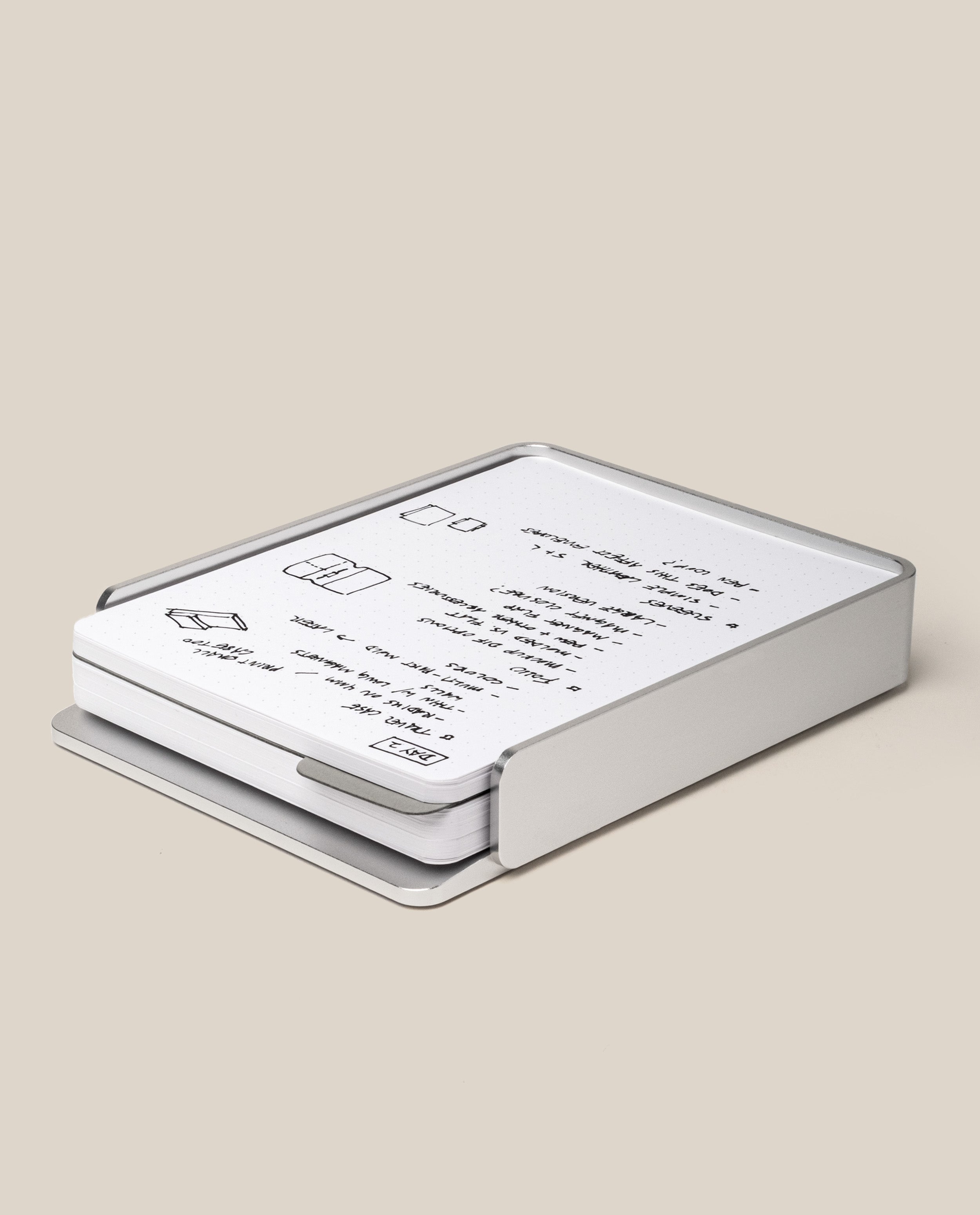 The Analog Capture Kit - Large (Silver Aluminum) features a sleek, rectangular aluminum tray with an open side revealing white cards printed with minimal black text and simple line drawings, all set against a plain beige background.