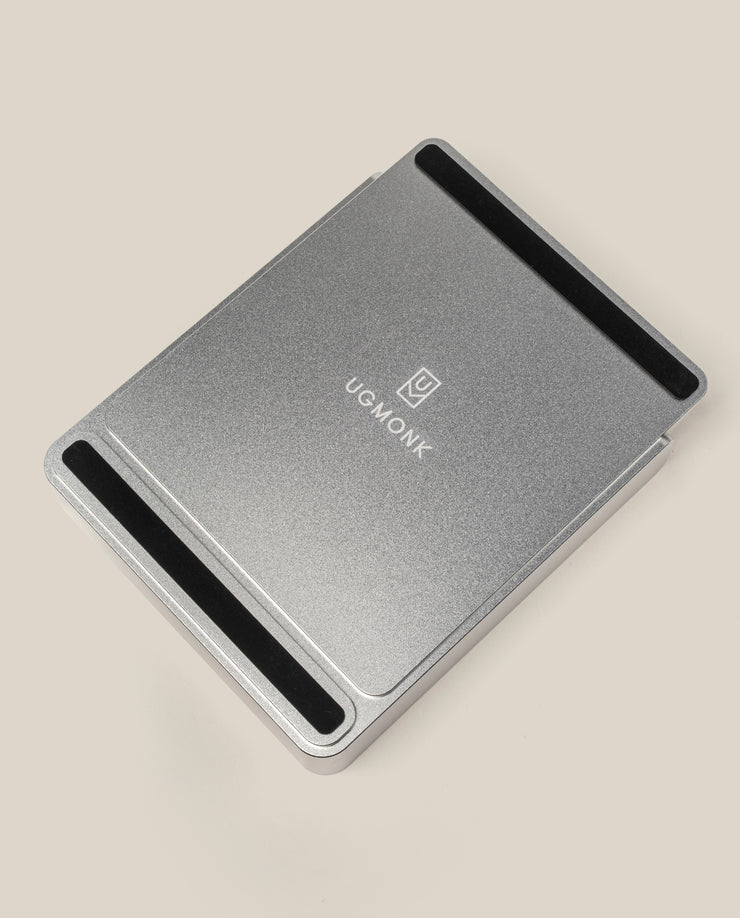 The Analog Capture Kit - Small & Large (Silver Aluminum) is a rectangular metal laptop stand with black non-slip strips at both ends and the UGMONK logo centered, matching the minimalist Dot Grid Cards, shown on a plain beige background.