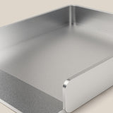 A close-up of the Analog Capture Kit - Small & Large (Silver Aluminum), a rectangular tray with raised sides and open front, ideal for organizing Dot Grid Cards, shown on a light beige surface.